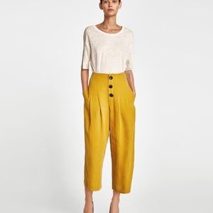 PLEATED TROUSERS WITH BUTTONS